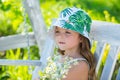 Beautiful blond little child girl with long hair smelling flower. Spring child face. Funny kids face. Happy little blond Royalty Free Stock Photo