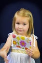 Beautiful blond little girl reading