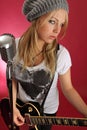 Beautiful blond playing electric guitar Royalty Free Stock Photo