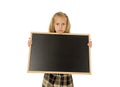 Beautiful blond schoolgirl sad moody and tired holding and showing small blank blackboard Royalty Free Stock Photo