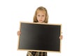 Beautiful blond schoolgirl sad moody and tired holding and showing small blank blackboard