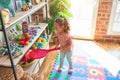 Beautiful blond toddler girl holding tennis racket standing at kindergarten Royalty Free Stock Photo