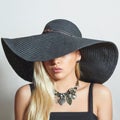 Beautiful Blond Woman in Black Hat. Close-up. Elegance Beauty Girl.Accessories. Lady in Jewelry