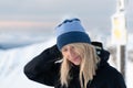 Beautiful blond woman in a blue cap on the Zawrat pass in the winter Tatra Mountains. Royalty Free Stock Photo