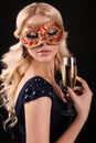 Beautiful blond woman in carnival mask,with glass of champagne Royalty Free Stock Photo