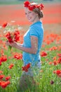 Beautiful blond woman in field with poppies Royalty Free Stock Photo