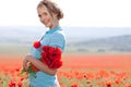 Beautiful blond woman in field with poppies Royalty Free Stock Photo