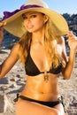 Beautiful blond woman in a hat on a beach Royalty Free Stock Photo