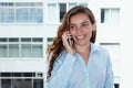 Beautiful blond woman laughing at phone Royalty Free Stock Photo