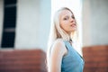 Beautiful blond woman posing in city street Royalty Free Stock Photo