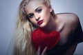 Beautiful Blond Woman with Red Heart. Beauty Girl. Show Love Symbol. Valentines Day Royalty Free Stock Photo