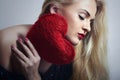 Beautiful Blond Woman with Red Heart. Beauty Girl. Show Love Symbol. Valentines Day