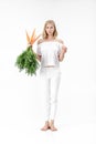 Beautiful blond woman showing rabbit and holding fresh carrot with green leaves on white background. Health and Diet Royalty Free Stock Photo