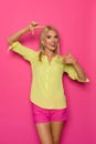 Beautiful Blond Woman In Vibrant Clothes Is Showing Frame Hand Sign