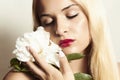 Beautiful blond woman with white flower and rep lips Royalty Free Stock Photo