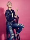 Beautiful blond young model posing in black leather jacket and b Royalty Free Stock Photo