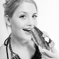 Beautiful blond young woman eating chocolate cake Royalty Free Stock Photo