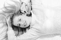 Beautiful blond young woman lying on bed happy Royalty Free Stock Photo