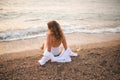 Beautiful blonde adult girl wear elegant swimsuit and white shirt resting over blue sea Royalty Free Stock Photo