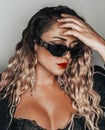 Beautiful blonde alternative woman with curly hair and sunglasses