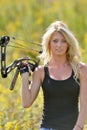 Beautiful blonde archer in field of wildflowers Royalty Free Stock Photo