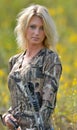 Beautiful blonde archer in field of wildflowers Royalty Free Stock Photo