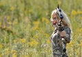 Beautiful blonde archer in field of wildflowers Royalty Free Stock Photo