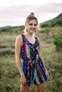 Beautiful blonde with beautiful eyes in blue overalls in nature, sunset sun Royalty Free Stock Photo