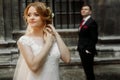 Beautiful blonde bride in luxury white wedding dress posing outdoors in italian street, face closeup of gorgeous newlywed Royalty Free Stock Photo