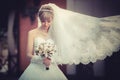 Beautiful blonde bride with wedding bouqet in the hands