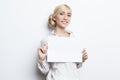 Beautiful blonde business woman holding blank paper Royalty Free Stock Photo