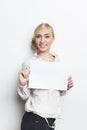 Beautiful blonde business woman holding blank paper in front of her for easy text insertions Royalty Free Stock Photo