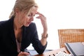 Beautiful blonde business woman with long blond hair, make-up and hairdo, wearing a dark skirt and pink blouse. Royalty Free Stock Photo