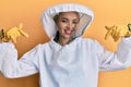 Beautiful blonde caucasian woman wearing protective beekeeper uniform looking confident with smile on face, pointing oneself with