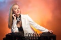 Beautiful blonde DJ girl on decks - the party