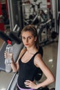 Beautiful blonde drinking water in the gym Royalty Free Stock Photo