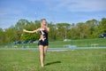 Beautiful blonde female twirler or majorette performs