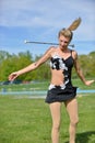 Beautiful blonde female twirler or majorette performs