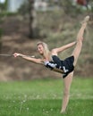 Beautiful blonde female twirler or majorette performs