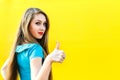 Beautiful blonde girl in blue dress showing finger up. Royalty Free Stock Photo