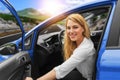 Beautiful blonde girl driving a car on the highway. Invitation to travel. Car rental or vacation. Royalty Free Stock Photo