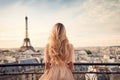 Beautiful blonde girl with Eiffel tower in Paris, France, Once in Paris. Back slim chic woman with long blond hair in dress on