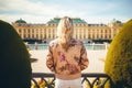 Beautiful blonde girl in front of the Schonbrunn Palace in Vienna, Austria, Female tourists standing in front of the Schonbrunn
