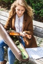 Beautiful blonde girl holds violin in autumn park Royalty Free Stock Photo