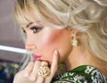 Beautiful blonde girl model shows off vintage Turkish, Oriental women`s, gold jewelry, earrings, rings, bracelets, pendant Royalty Free Stock Photo