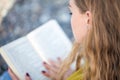 Beautiful blonde girl is reading a book on the beach Royalty Free Stock Photo