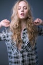 Beautiful blonde girl in a shirt with a light makeup and loose hair. Model tests. Royalty Free Stock Photo