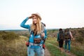 Beautiful blonde girl smiling, looking into distance, friends tourists background. Royalty Free Stock Photo