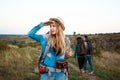 Beautiful blonde girl smiling, looking into distance, friends tourists background. Royalty Free Stock Photo