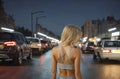 Beautiful blonde girl standing in a crop top at night